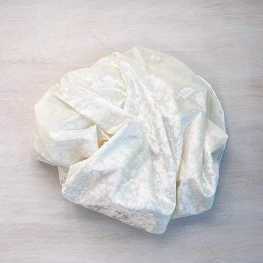 A fabric sample of ivory crushed velvet to be used to create a custom made corset bra