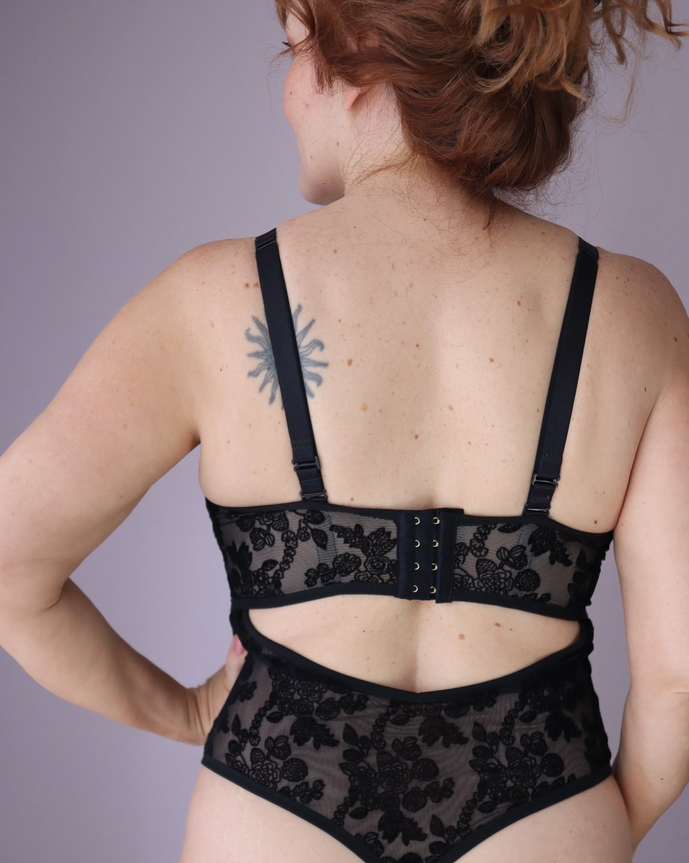 Rubies Custom Bras: back shot of our custom bespoke bodysuit in black sheer velvet. Made to order and made to measure in Canada and USA. Book an online fitting with an bra fit specialist and expert. Specializing in asymmetry, mastectomy, nursing, large cup sizes, and other special needs.