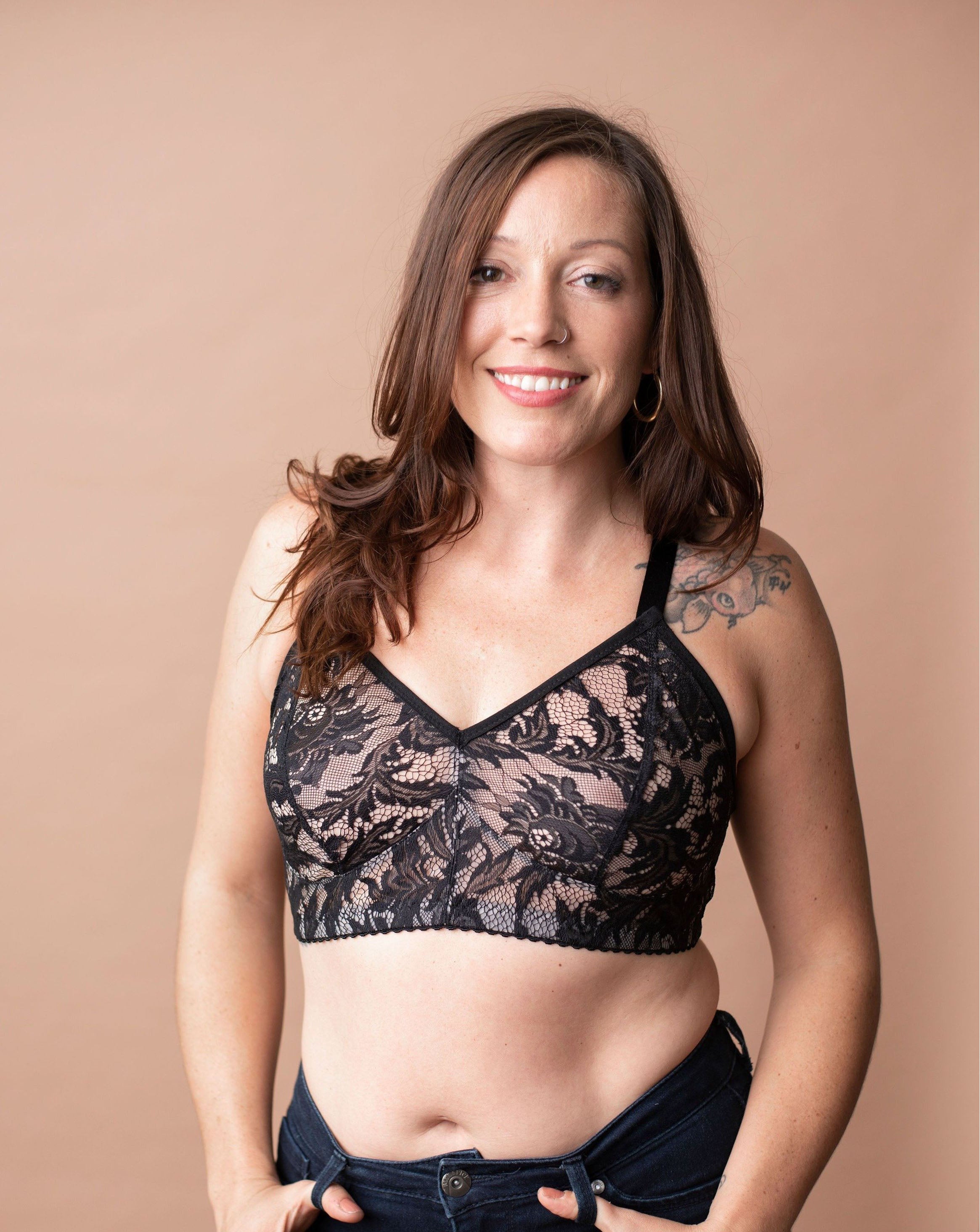 Smiling model with long brown hair wearing a black lace Viva Bra from Rubies Custom Bras.