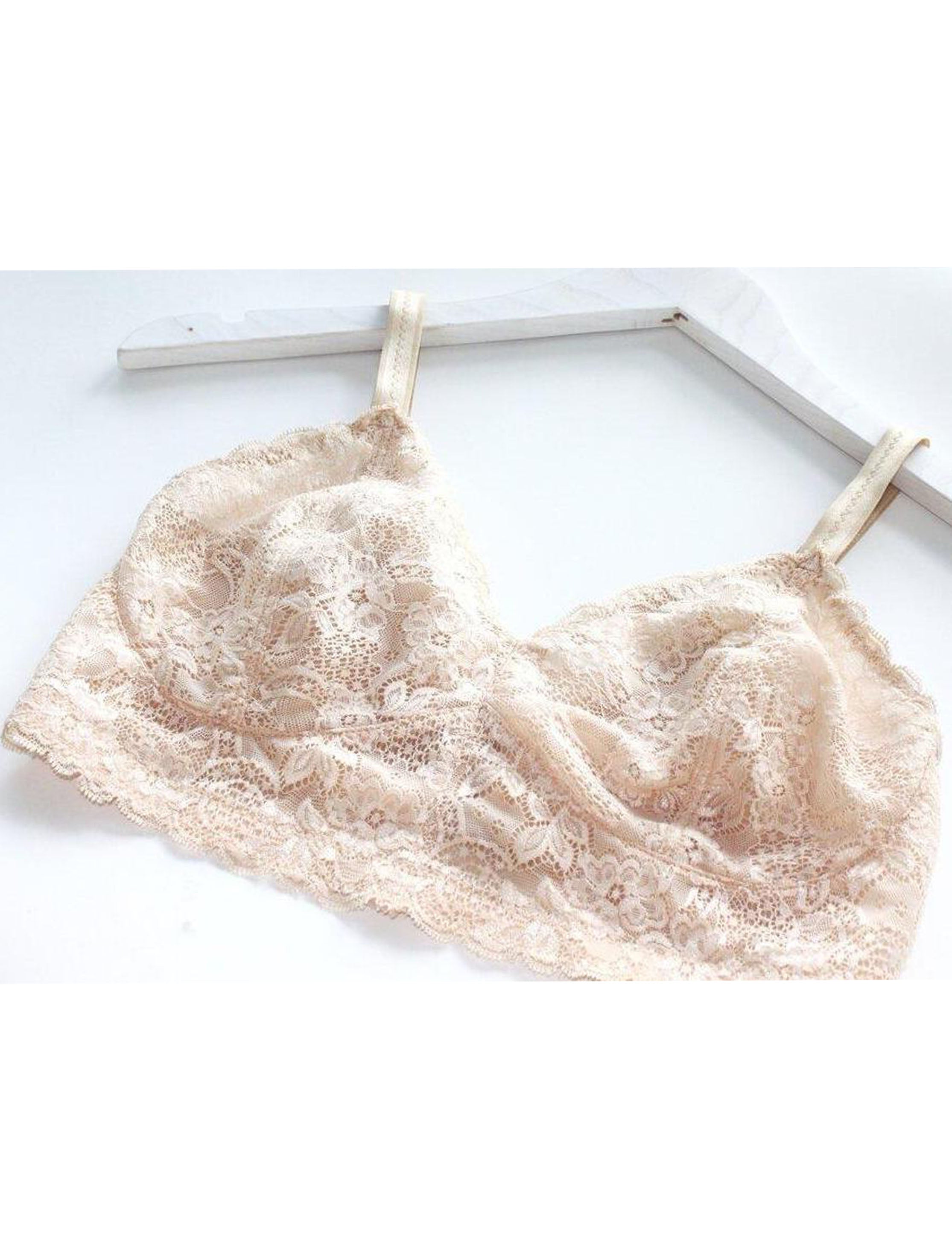 Custom made wireless bra in beige scalloped lace fabric on a hanger, made to order by Rubies Bras.