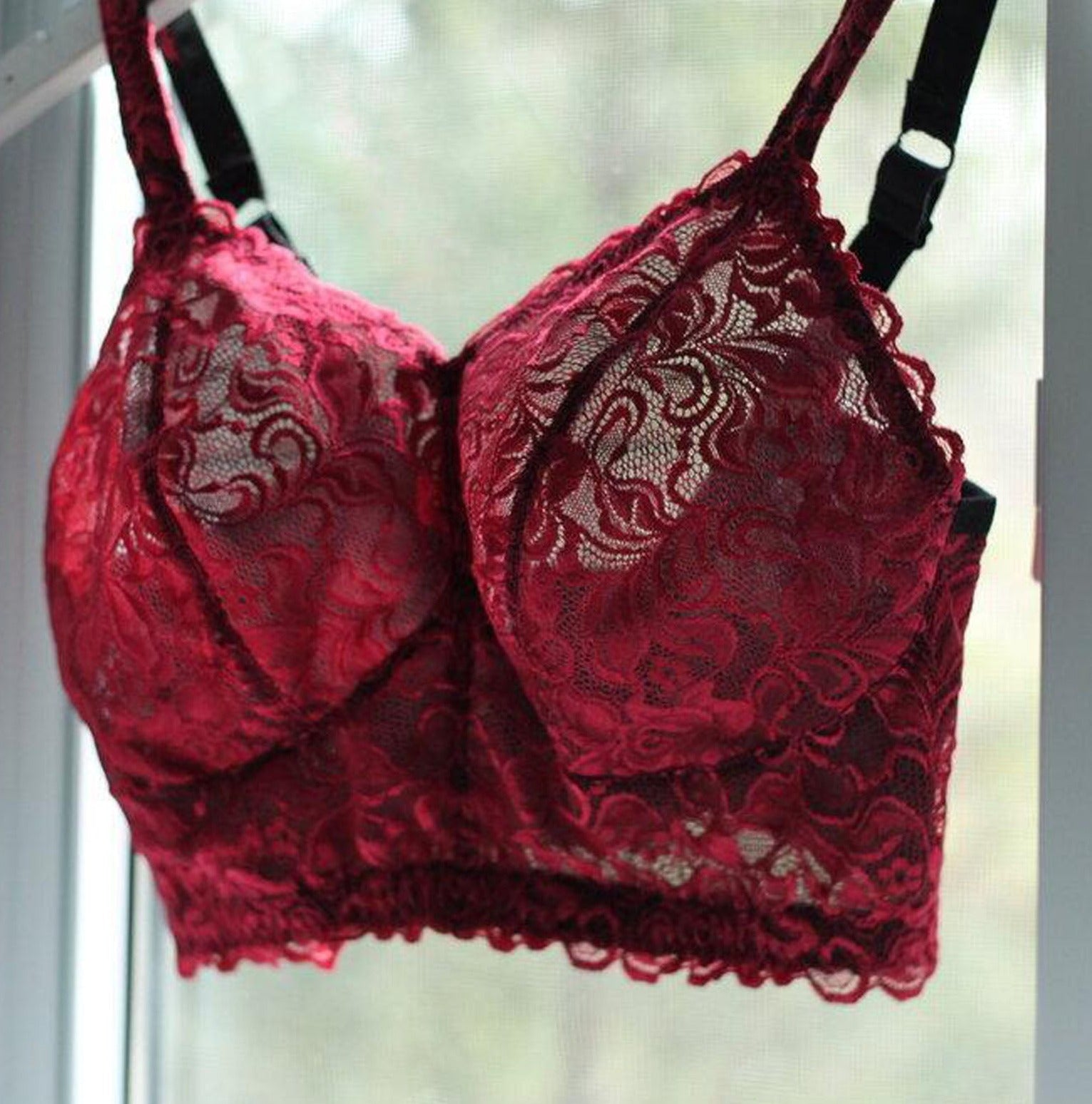 Custom made wireless bra in red scalloped lace fabric on a hanger, made to order by Rubies Bras.