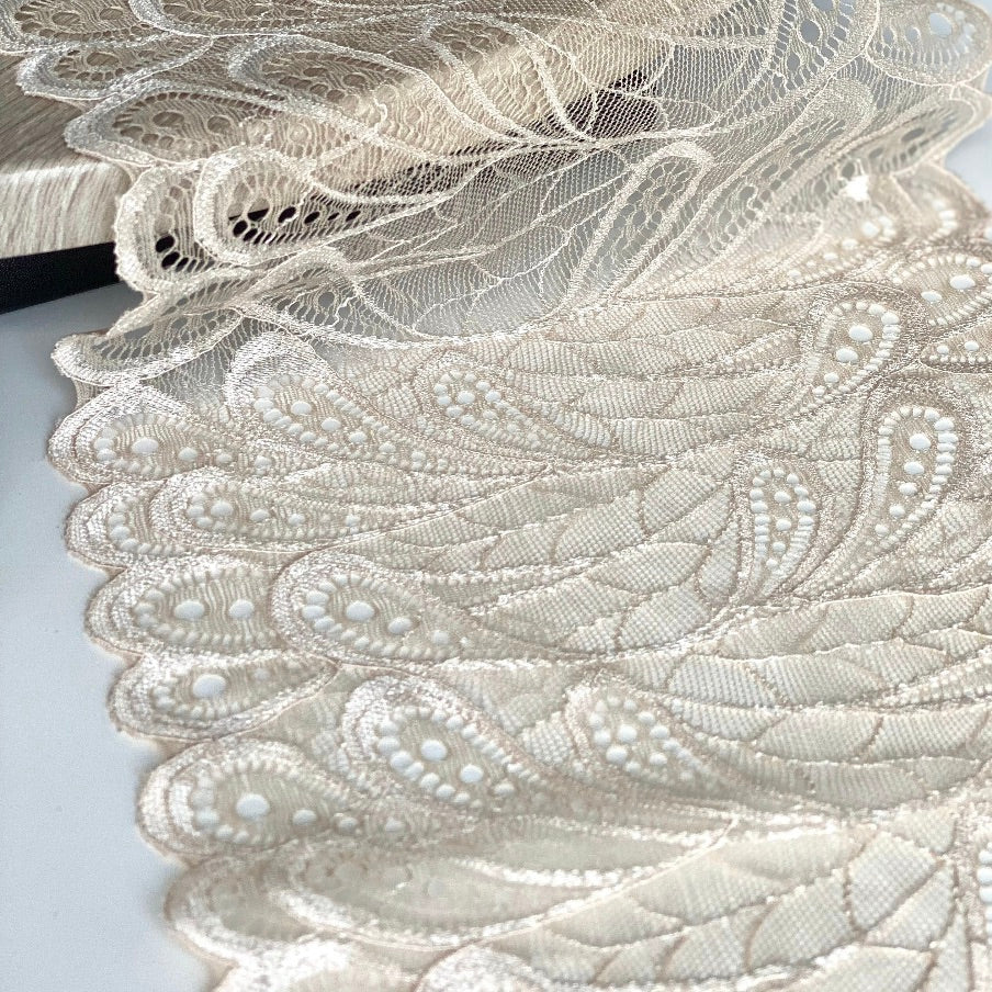 Close up of lace in the color beige from Rubies Custom Bras. Our fabrics are long lasting and high quality. Book a online fitting appointment to have a custom bra made today. A custom bra is worth the price because it is custom made to fit and made to last years.