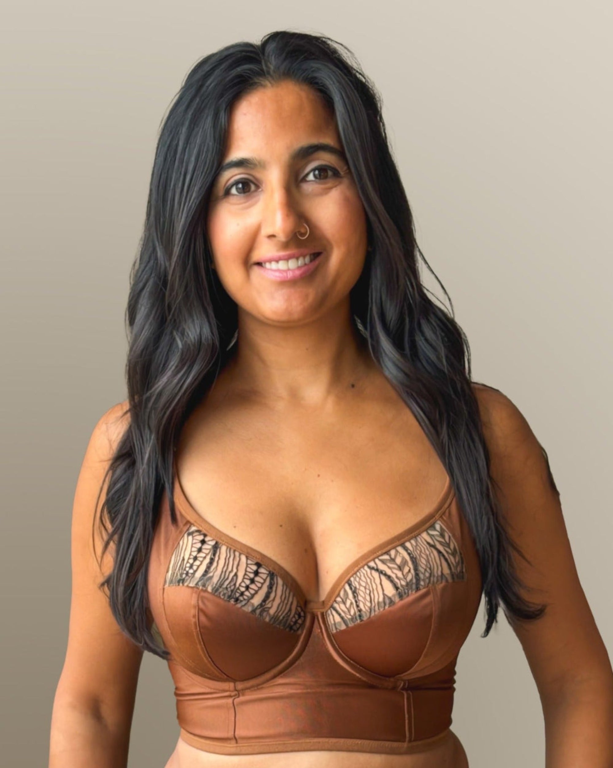 Model wearing a custom bustier bra that's wired, push up, sexy and has cleavage. This bra can be worn under your clothes are as a sexy top. Rubies Bras are customized for anyone's special needs. Perfect for special occasions or those wanting to treat themselves with a special premium luxury bra that's ethically made in Toronto Canada and the USA.