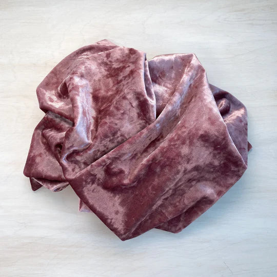 A fabric sample of pink crushed velvet to be used to create a custom made corset bra