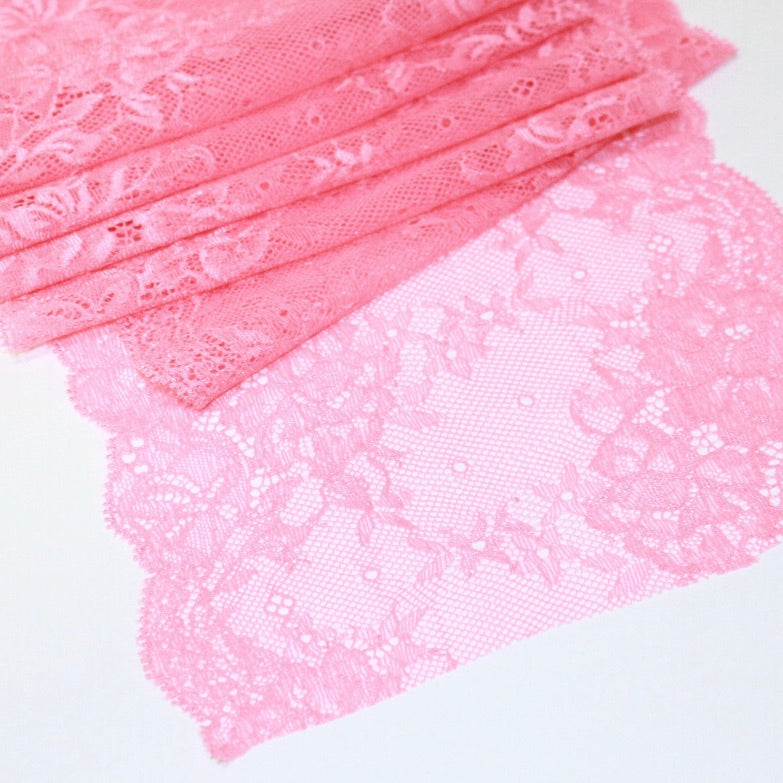 Close up of lace in the color pink from Rubies Custom Bras. Our fabrics are long lasting and high quality. Book a online fitting appointment to have a custom bra made today. A custom bra is worth the price because it is custom made to fit and made to last years.