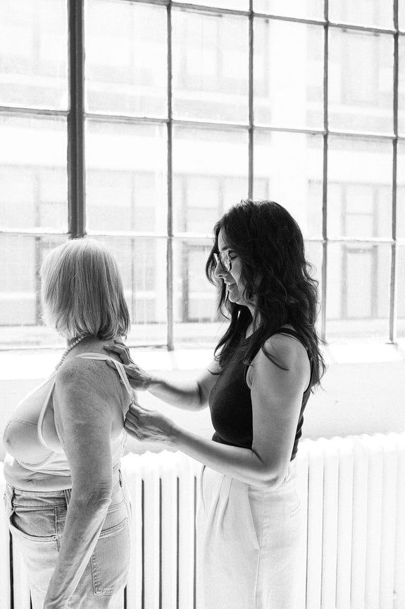 Ruhee, founder of Rubies bras measures client in bra fitting.