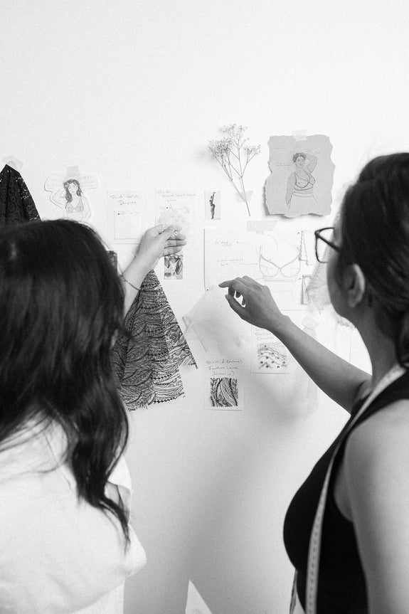 Rubies Bras team collaborating, curating patterns, material swatches, and sketches.