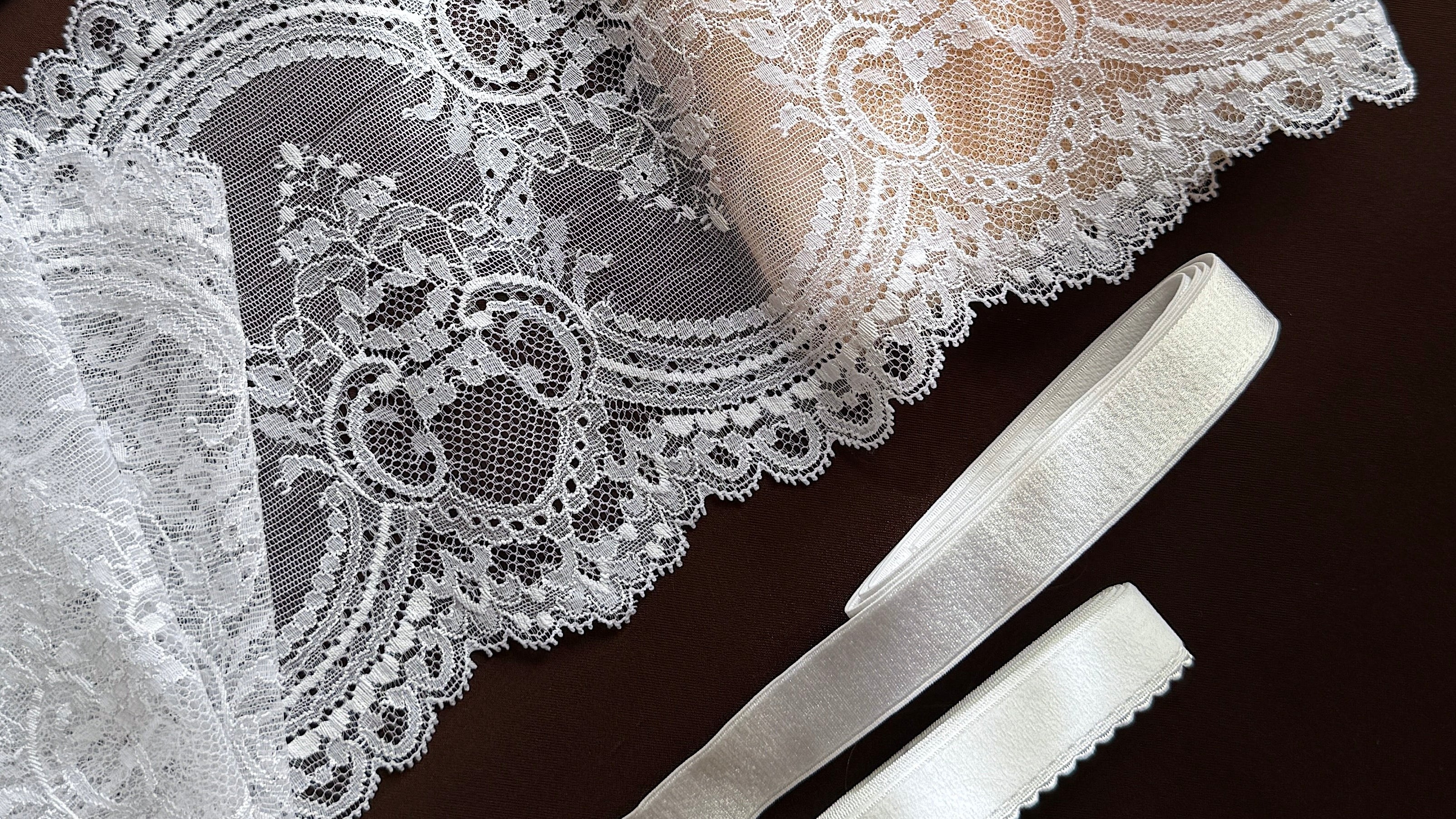 Lace trim, soap, and small items on a dark surface