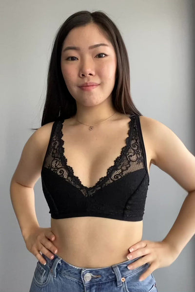 Rubies Bras client and model wearing a black plunge laces bra.