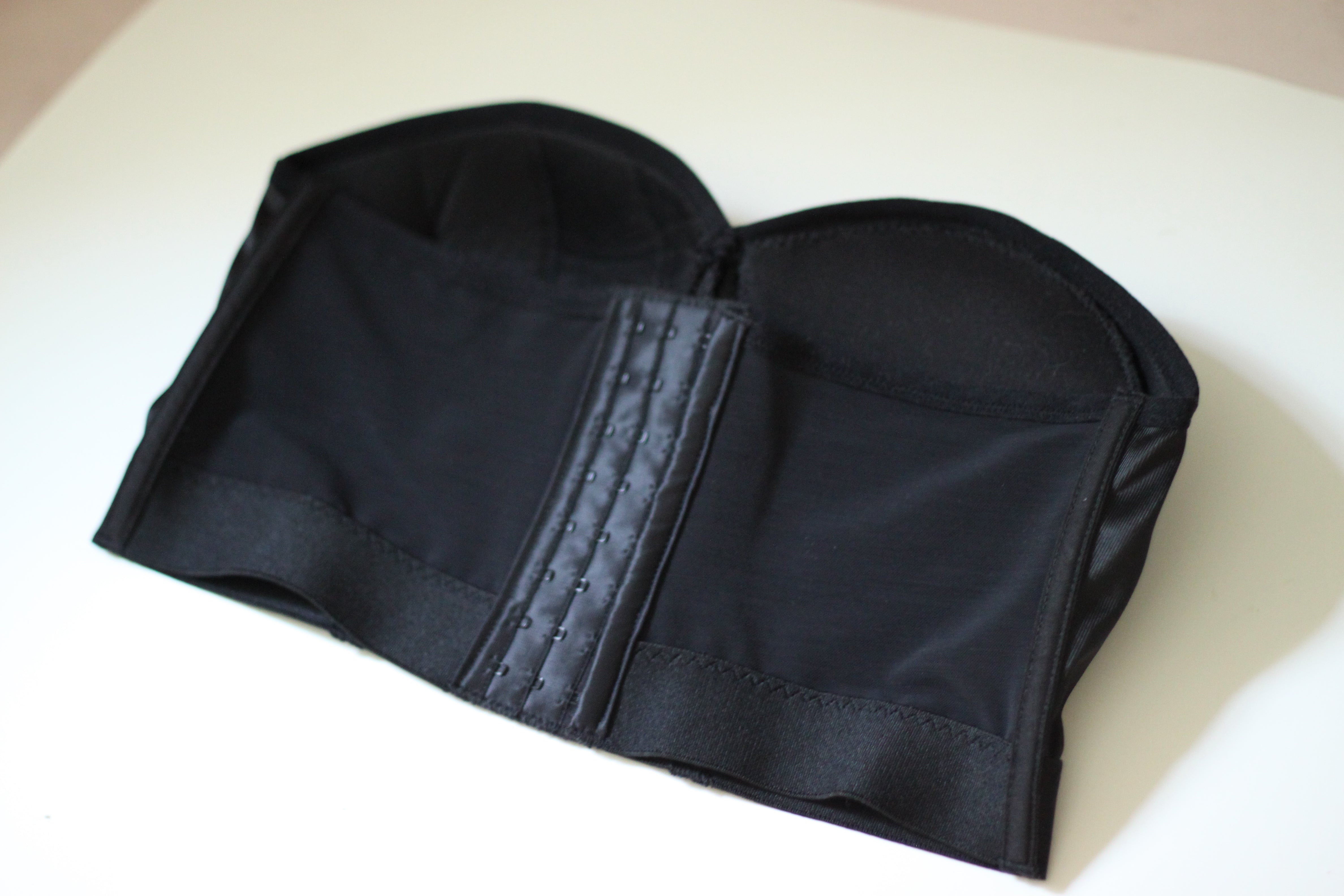 Flat lay of Rubies Bras strapless bra. Back shot.