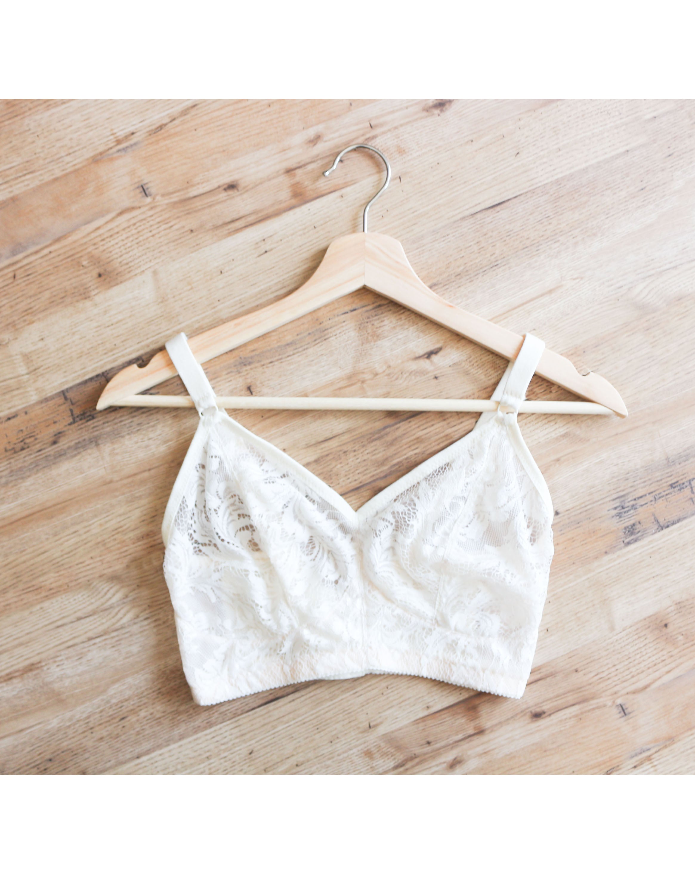 Flat lay of Rubies Custom Bras Chantilly lace bra in white. 
