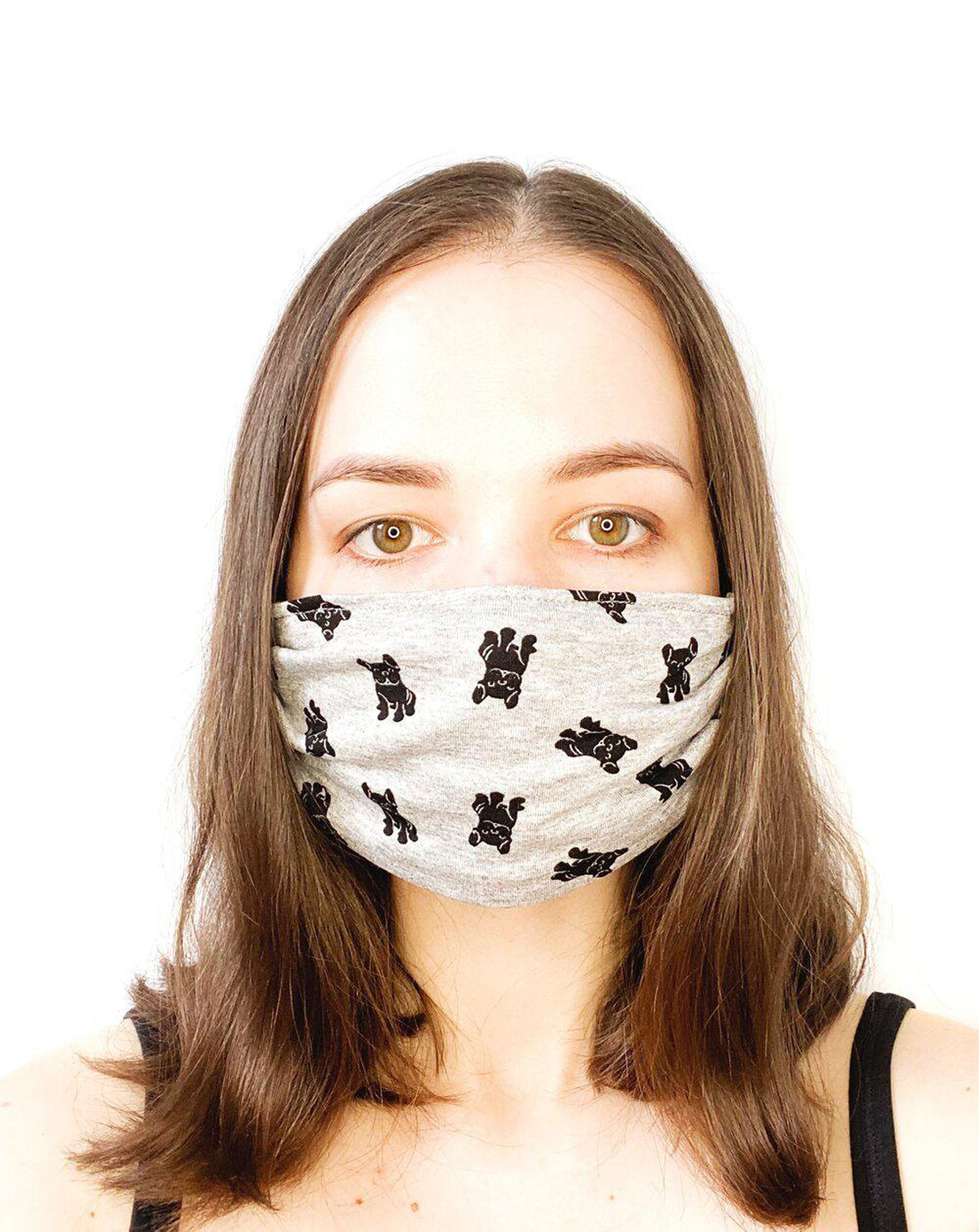 Model with brown hair wearing a black dogs on grey, organic cotton facemask.