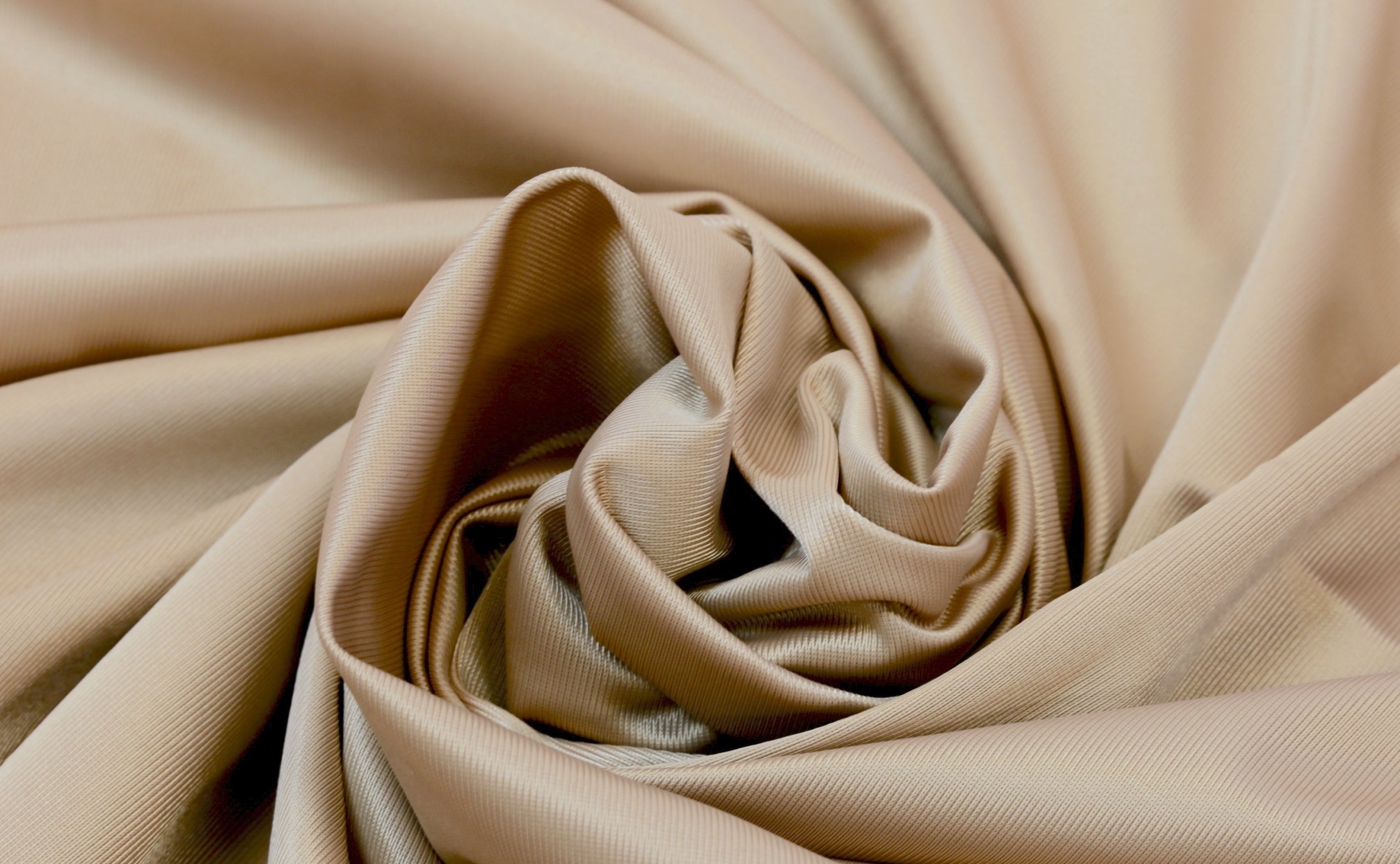 Rubies Bras Stretch Satin fabric in coppr. Close up.