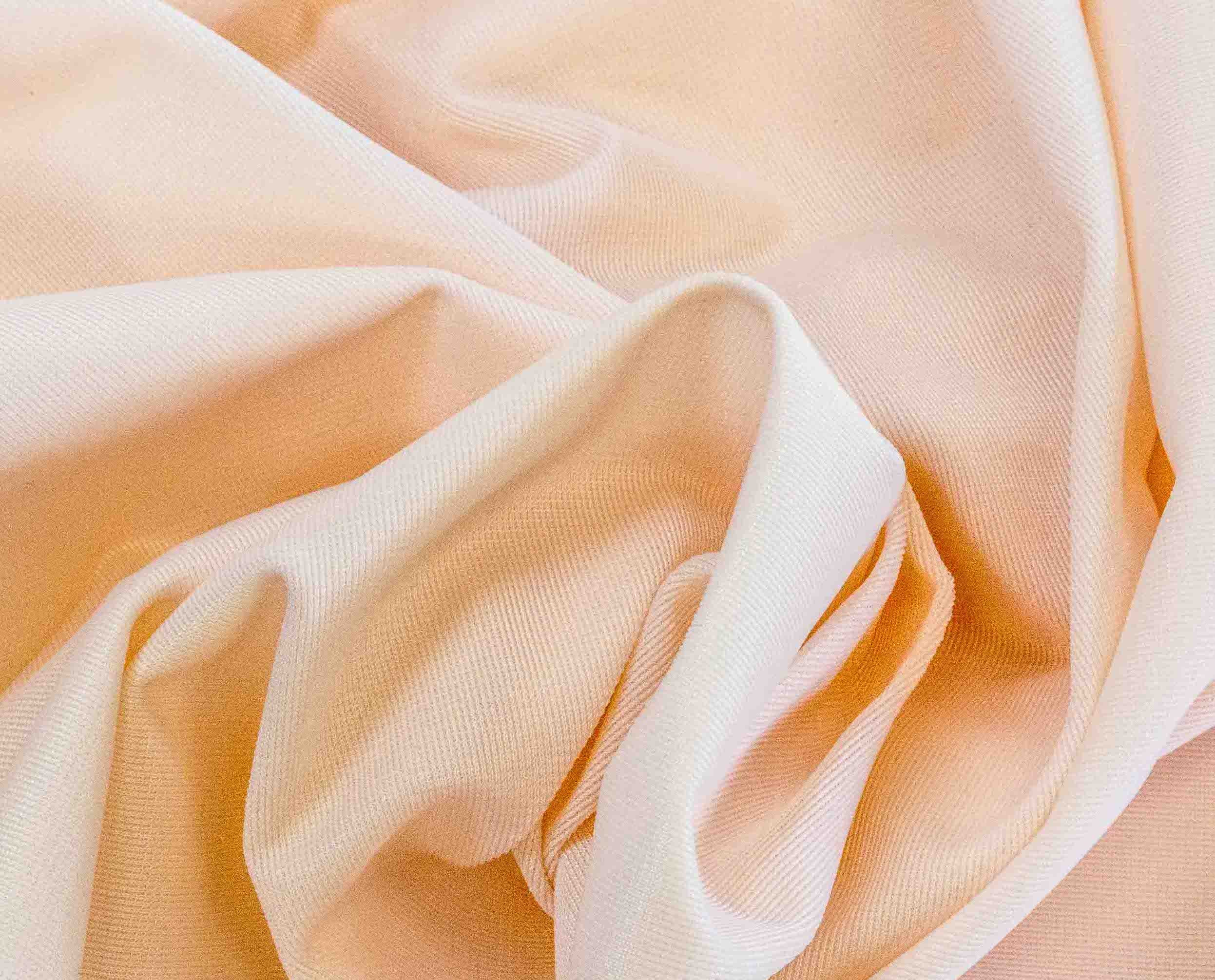 Rubies Bras Stretch Satin fabric in peach Close up.