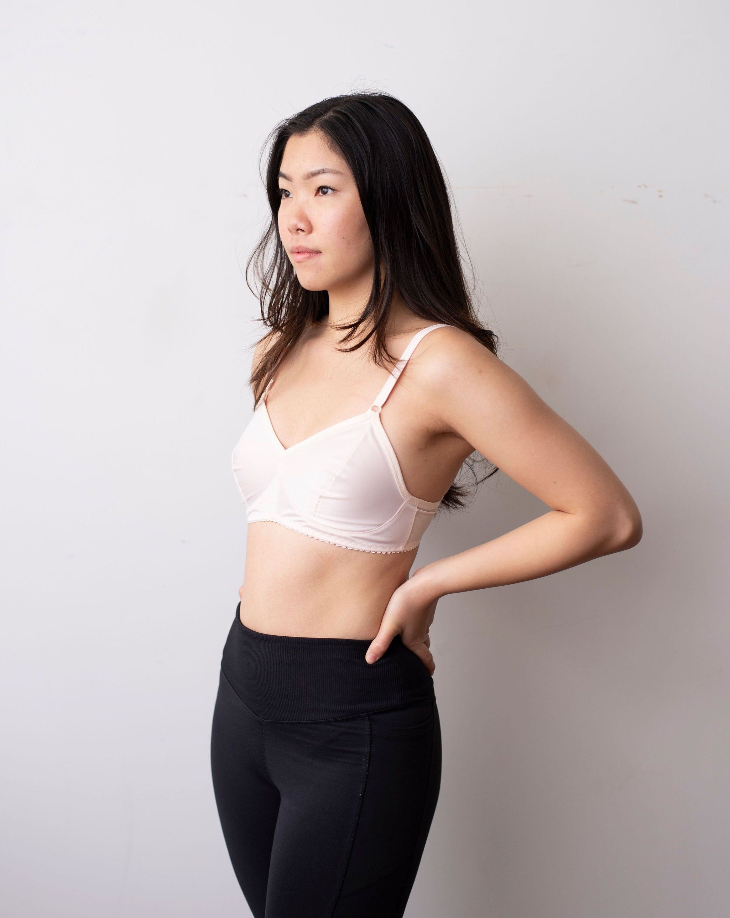 Side shot of black hair model wearing an ivory minimal solids bra.